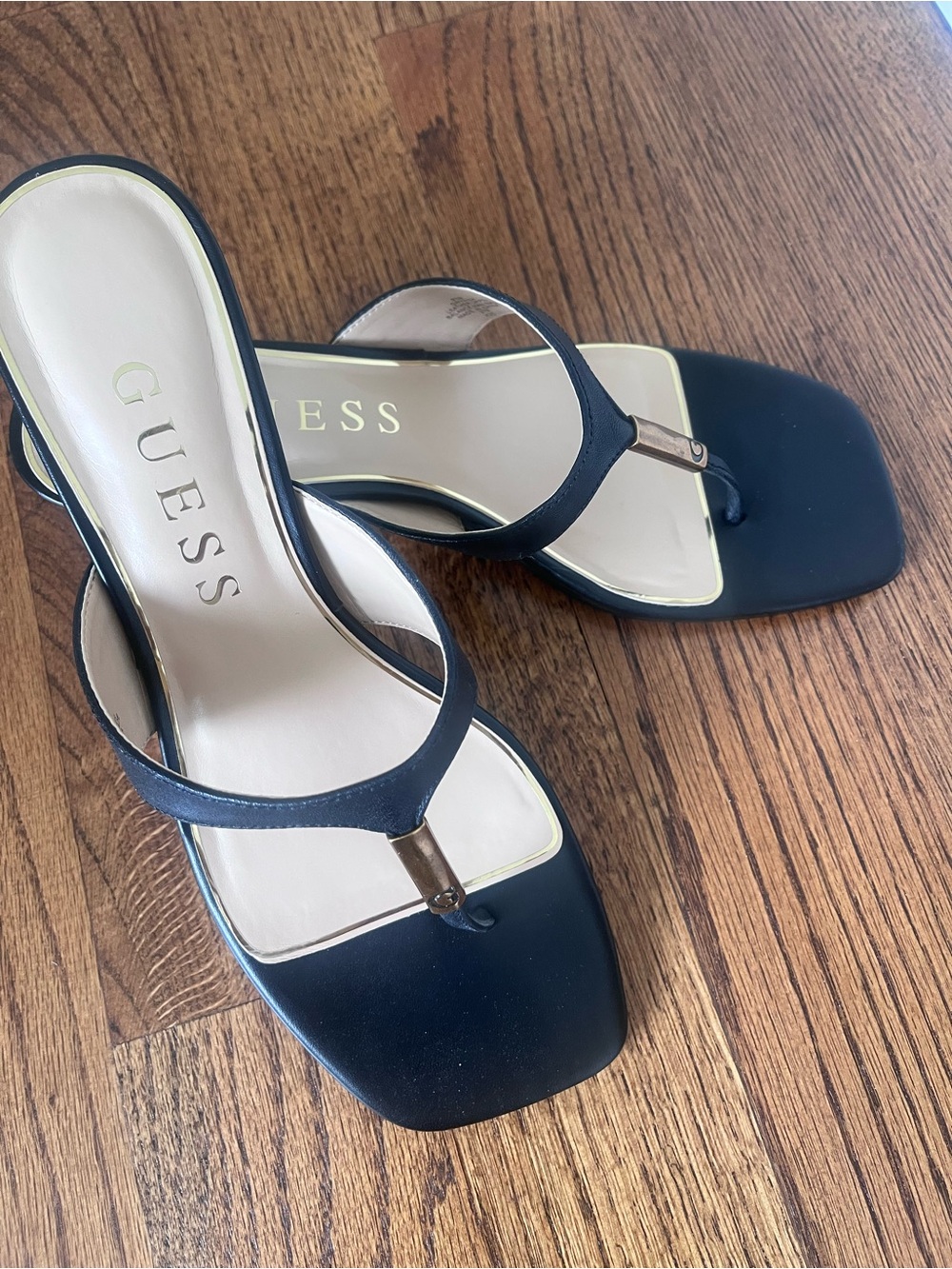 GUESS Black Square-Toe Toe-Post Sandals with Gold Accent.